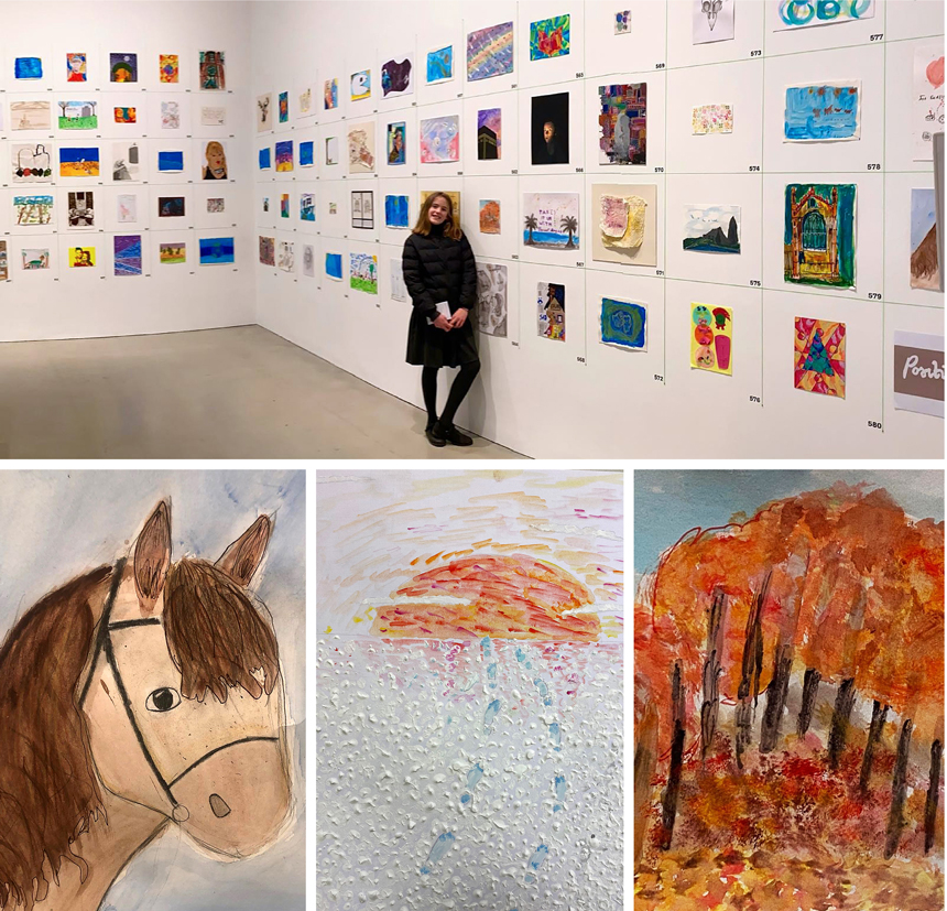 pupils standing next to their artwork in an exhibition