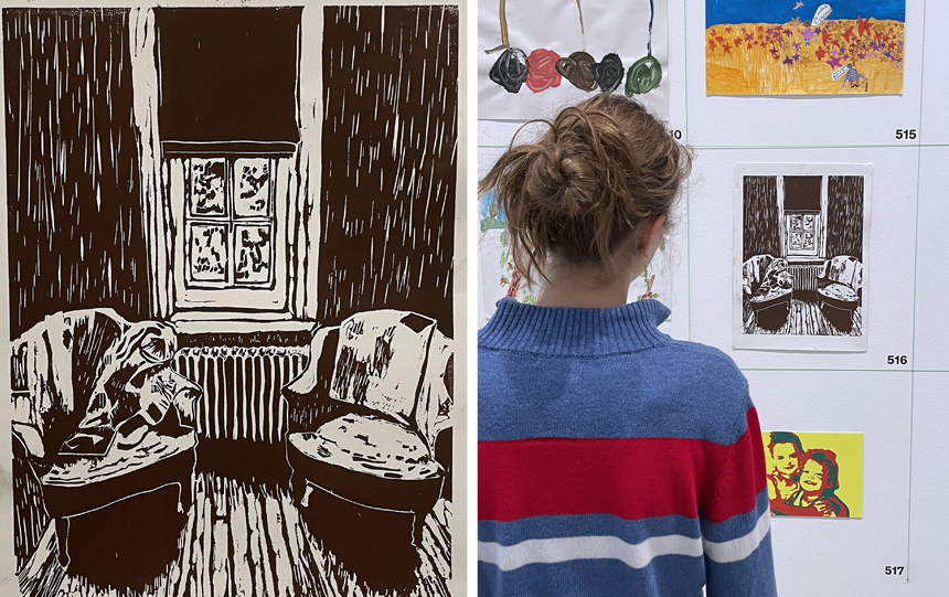 pupil standing next to her artwork in an exhibition