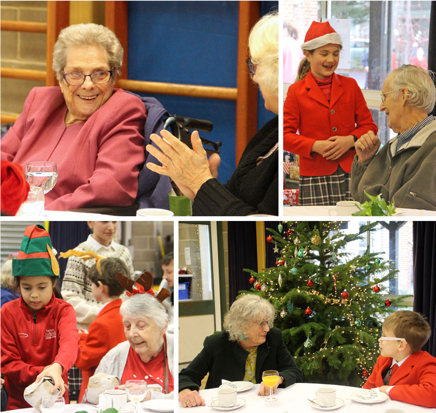 children chatting to senior citizens in a hall for a christmas party