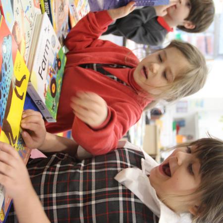 2 children looking at a book