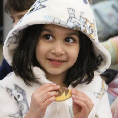 girl with hoodie eating biscuit