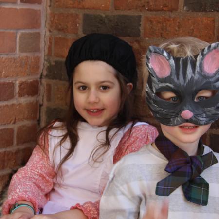 child with a hat and child with a cat mask