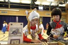 children dressed as Roman soldiers making crafts for the roman day