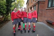 girls wearing odd socks for odd socks day