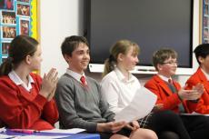 pupils in a debating competition in a hall