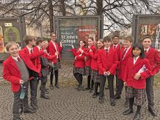 St John's College Choir choristers outside a poster of their tour