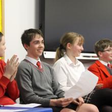 pupils in a debating competition in a hall