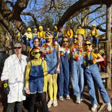 pupils dressed as Minions standing in front of a willow tree