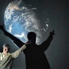 man giving a presentation to children about science in a space dome